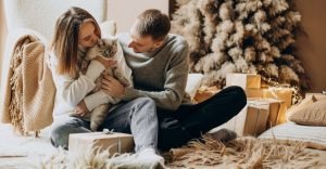 Couple with their kitten celebrating Christmas