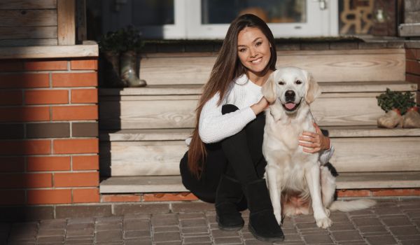 Young woman with retriever dog outdoor