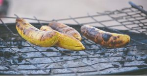 four plantains being grilled